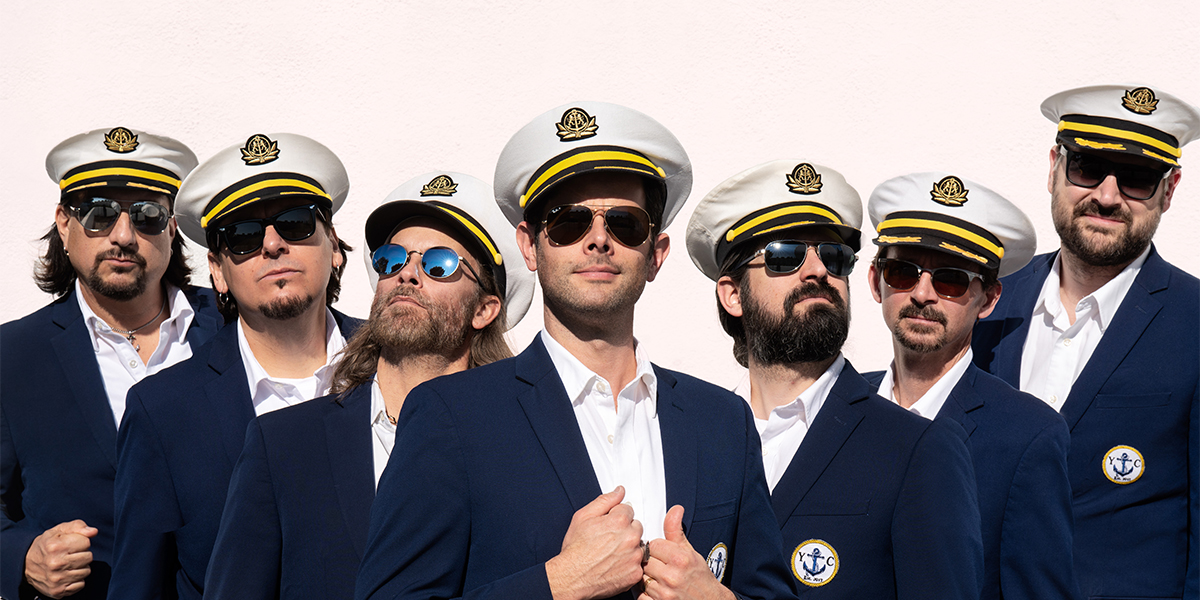 seven men in nautical suits and hats